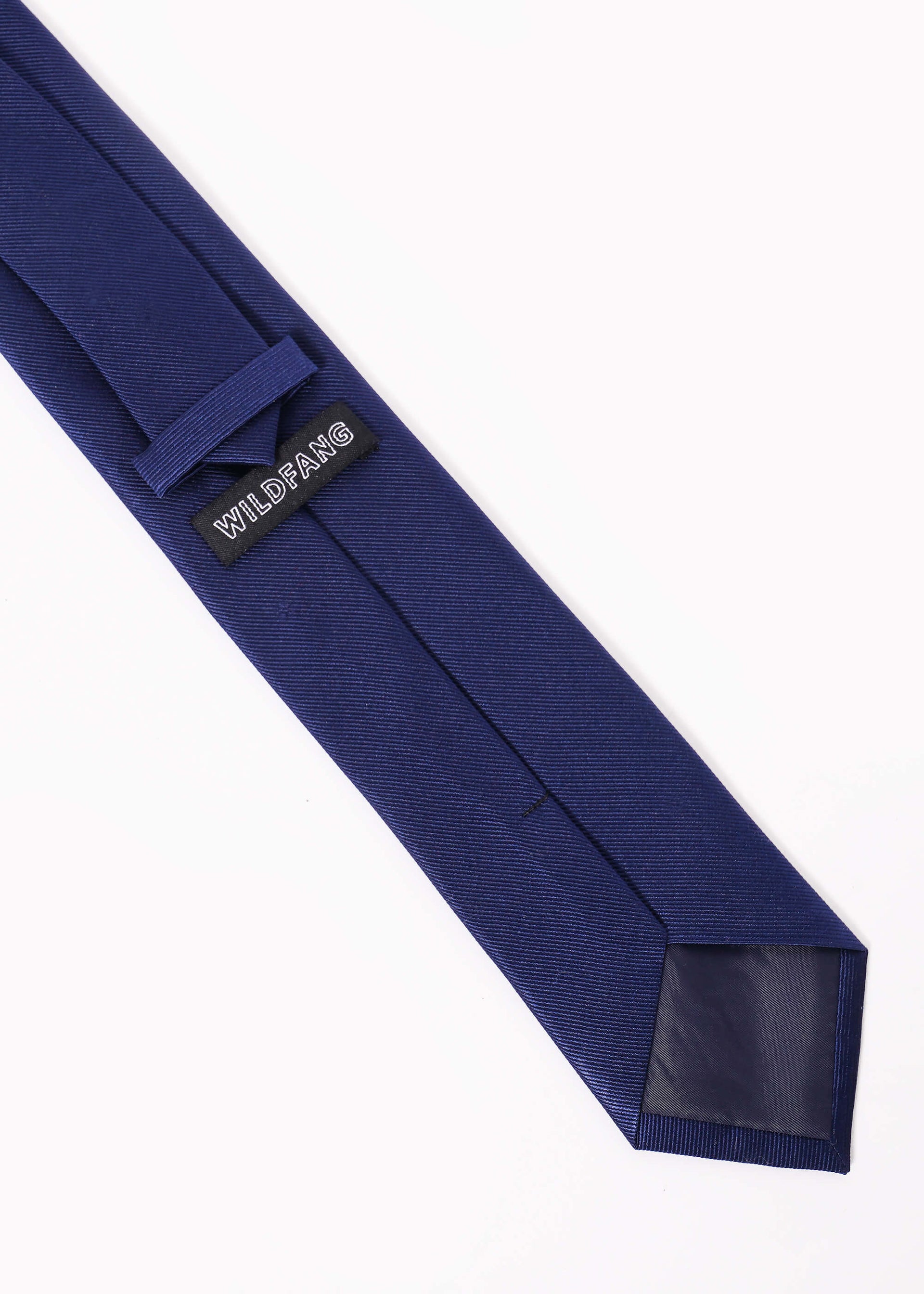 Back of navy blue tie on white background showing wildfang label.