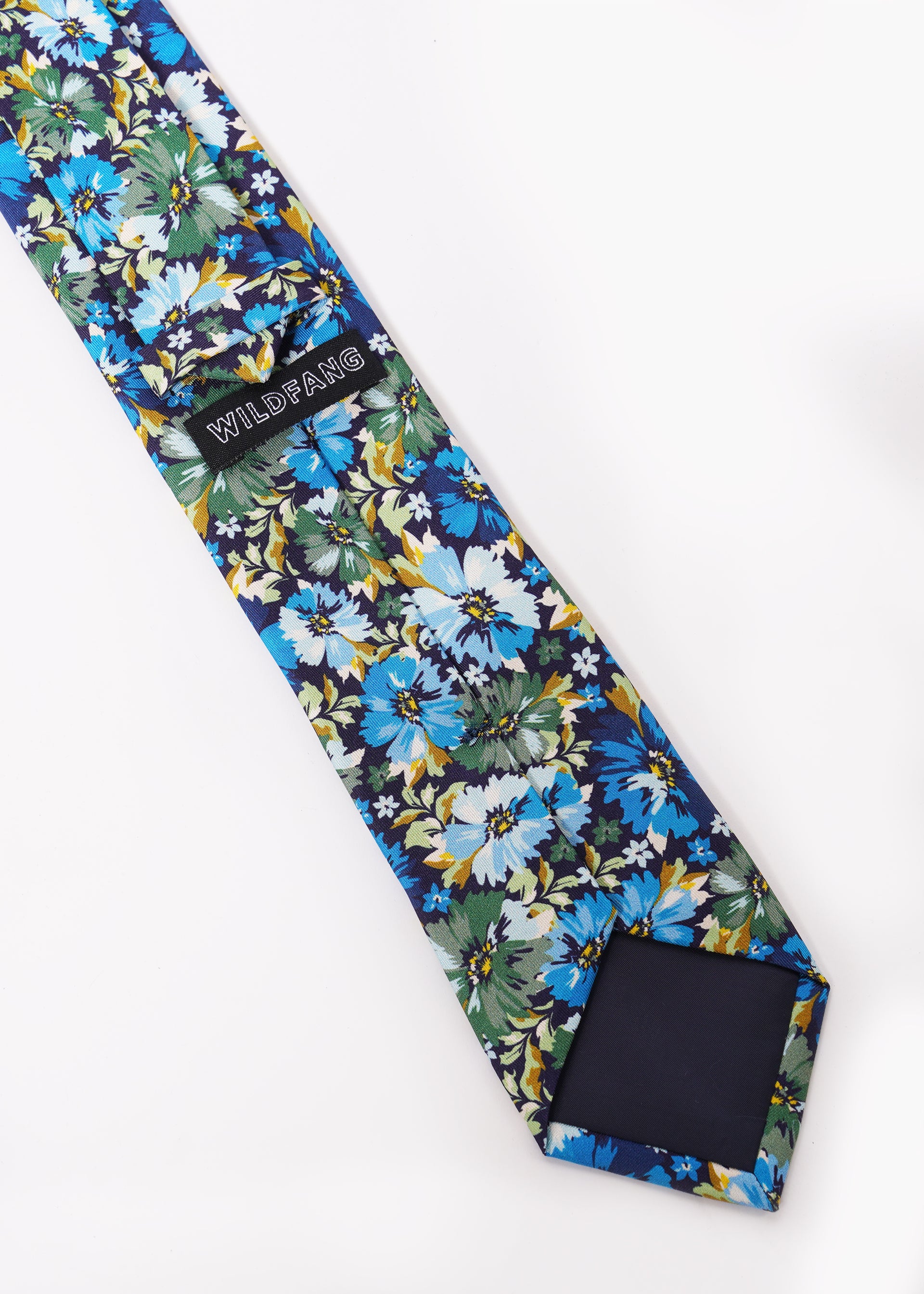 Back of blue and green floral patterned tie showing WILDFANG label.